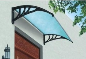 Curved doorway awning with a light blue translucent sheet supported by decorative black metal brackets above an exterior entrance.