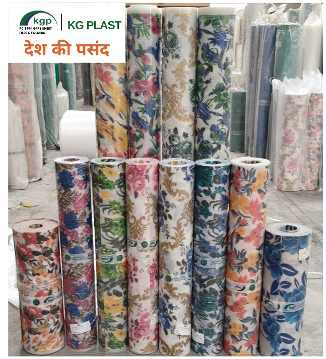 Rolls of floral and patterned plastic sheets by KG Plast wrapped in clear film.