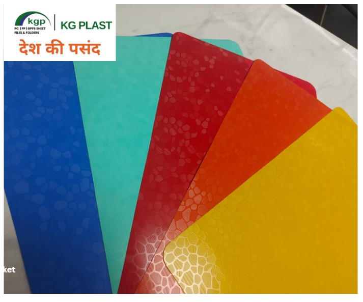 Fanned colorful rigid polypropylene sheets with a textured geometric pattern in blue, teal, red, orange, and yellow by KG Plast.