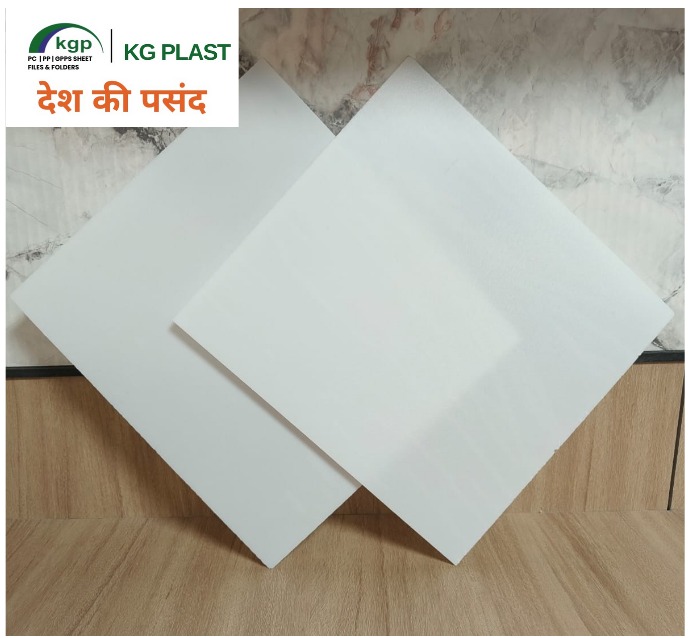 Two diamond-angled white plastic light diffuser sheets displayed on a wooden surface by KG Plast.